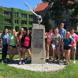ETS students posing around a statue at Winona State University