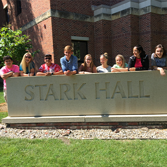 ETS students posing for a picture in front of Stark Hall at Winona State University