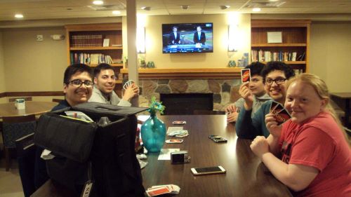 ETS students playing uno in a hotel lounge area