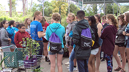 ETS students at a garden center listening to a staff member