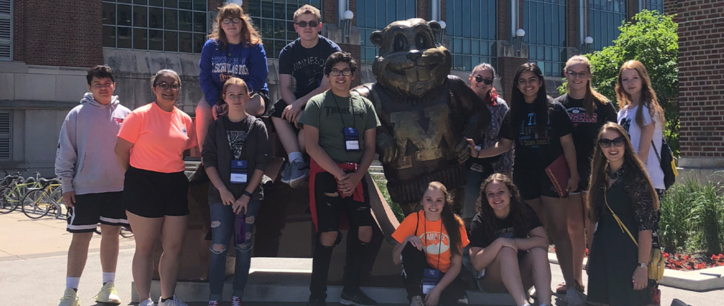 ETS students, visiting the University of Minnesota campus, posing for a photo with the Goldy Gopher statue