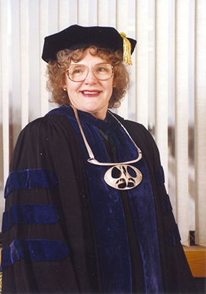 a person wearing a graduation gown and hat