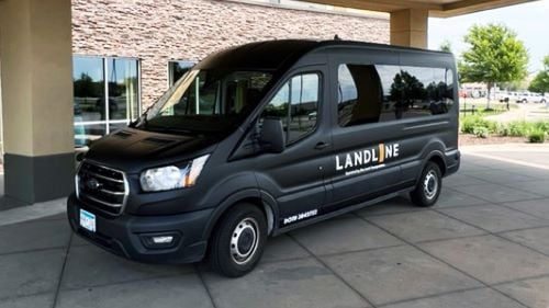 Landline transit van parked outside of the Courtyard by Marriott Hotel & Event Center in Mankato