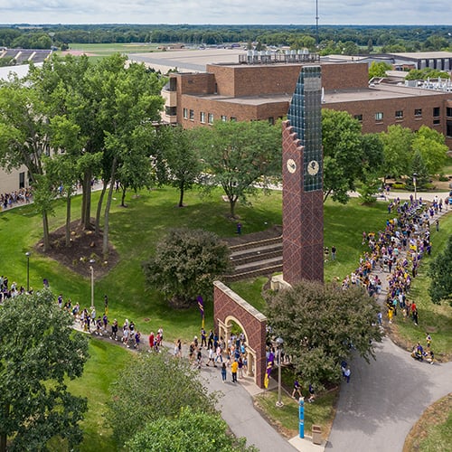 Ariel view of students gathering by the arch