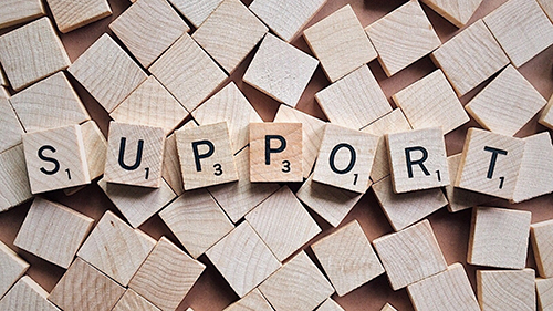 Support spelled out on wooden blocks