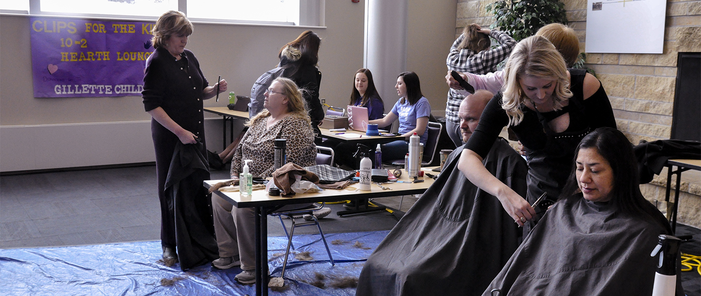 Hairdressers giving free haircuts to people at the CSU in the Clips for the Kids Events