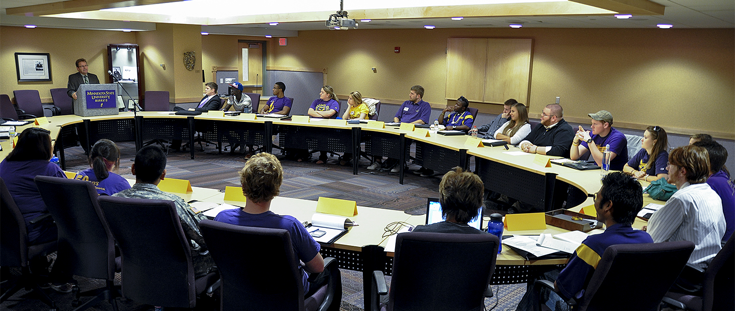 Members of Student Government in a meeting with a higher authority figure of the College