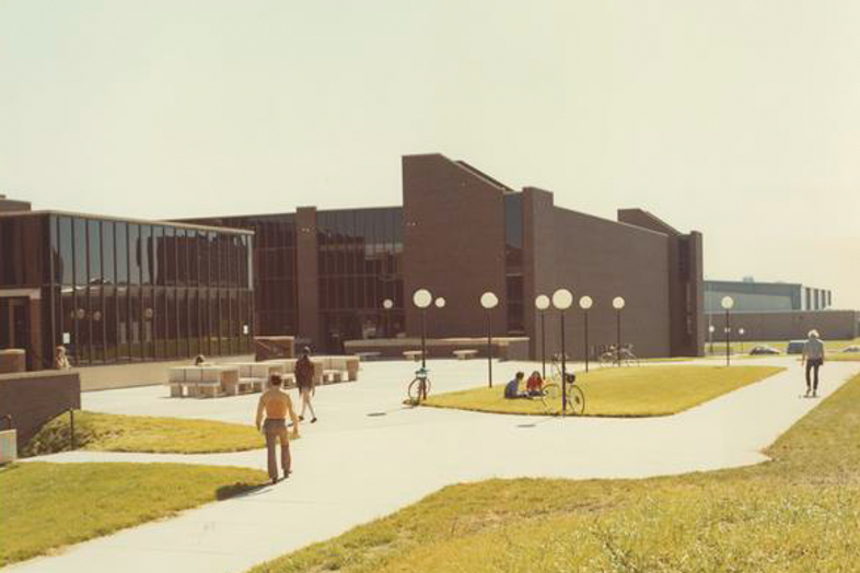 Students walking outside on campus in 1975