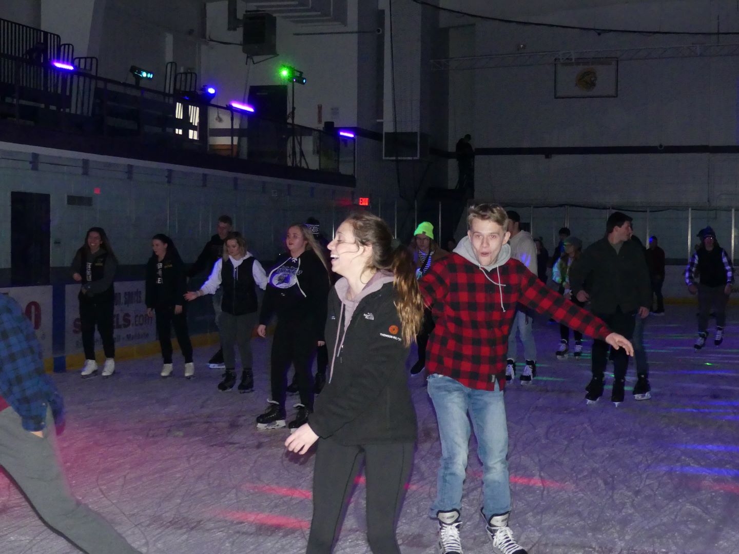 people ice skating AT ASA with black lights