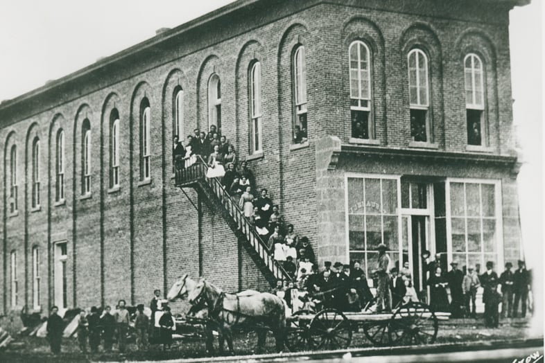a group of people sitting on a staircase outside a building