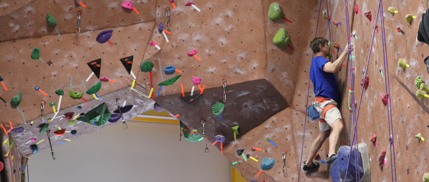 a rock climbing wall with colorful objects