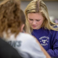 Two students sitting down at a table studying