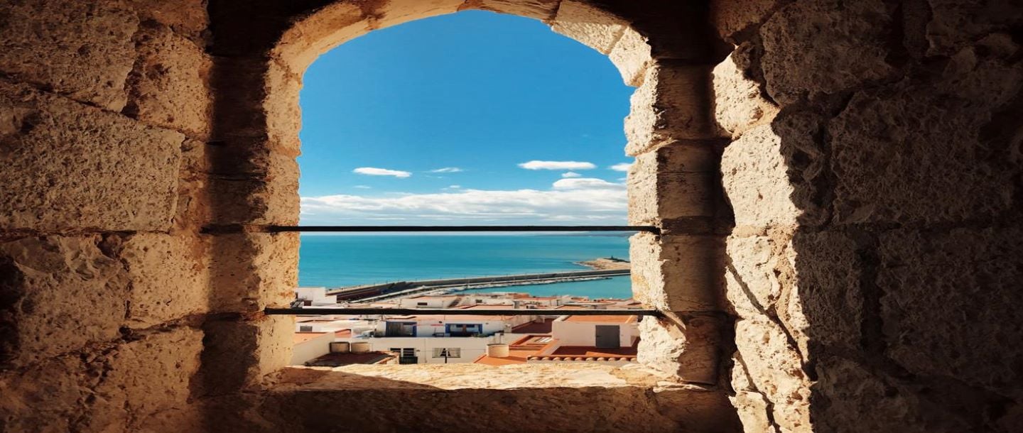 View from a stone building window overlooking the sea