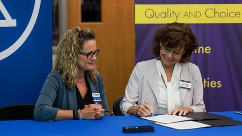 Laura Beasley and Teri Wallace sign a Maverick (Nursing) Advance (Transfer) Plan agreement at the Riverland Community College