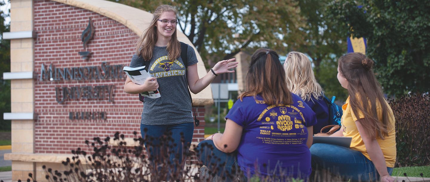 Four female students studying outside on campus