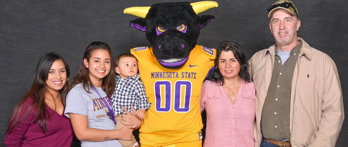 family posing with the mnsu mascot