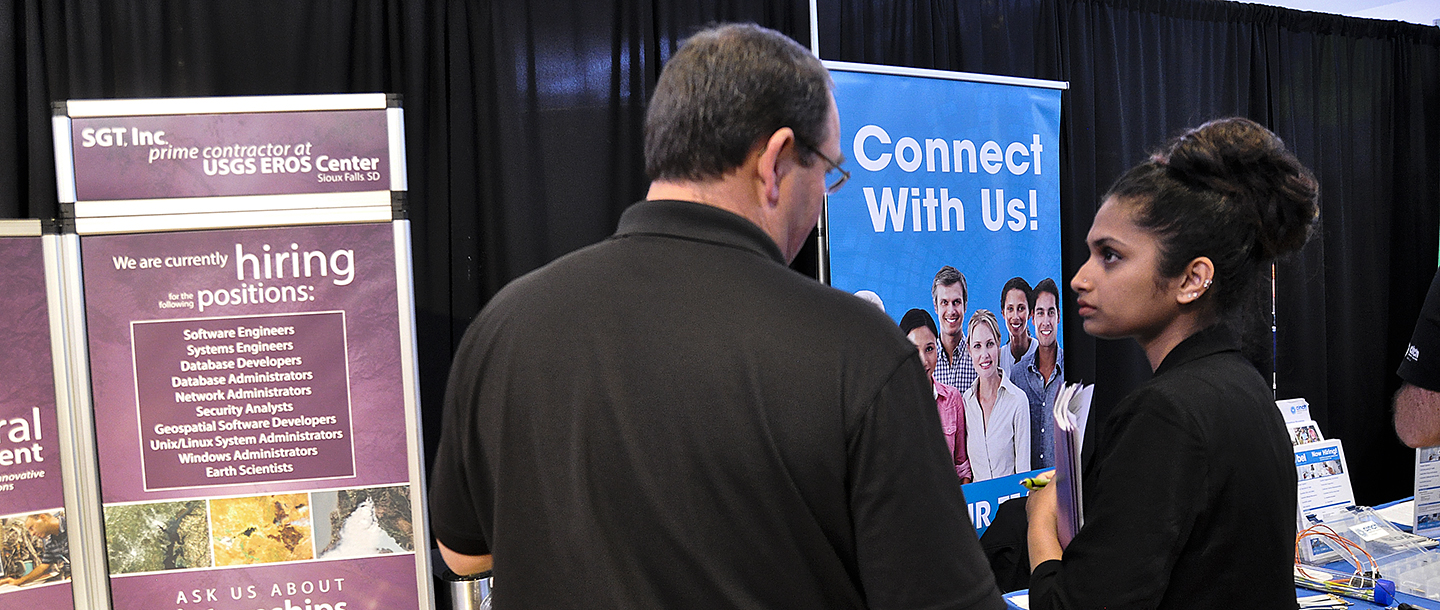 students speaking with companies and connecting with recruiters for jobs at the career fair in CSU