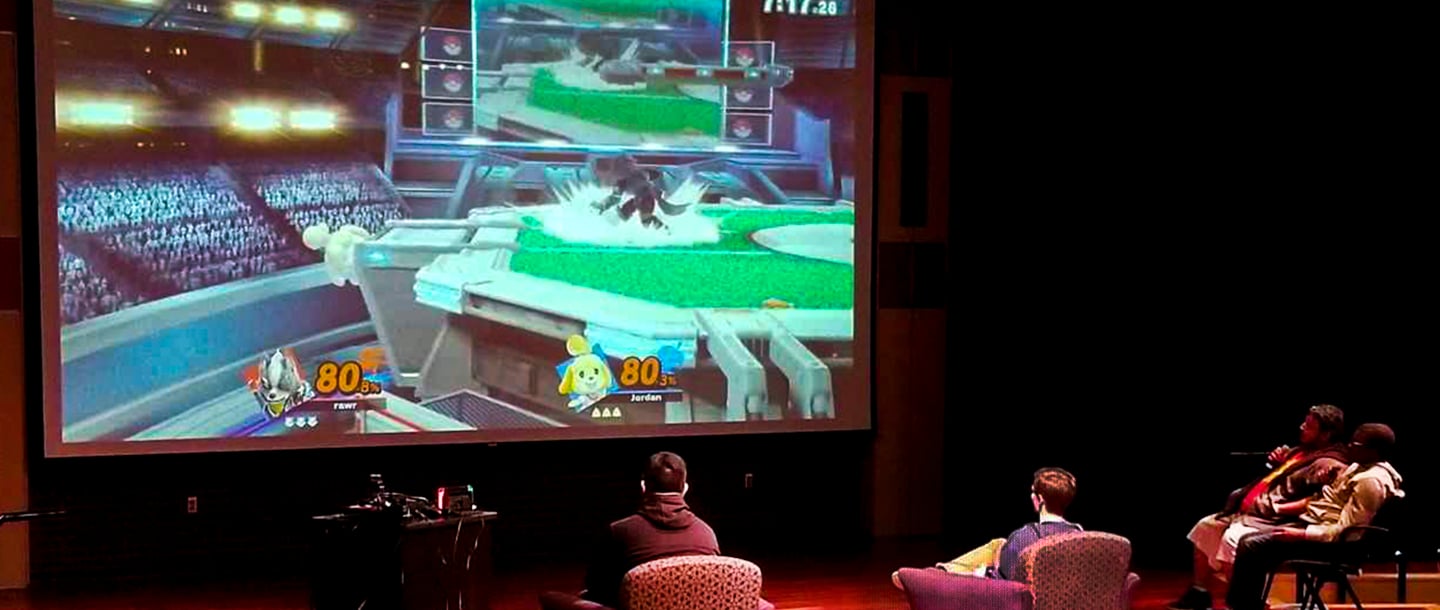  Students playing a video game in front of a huge screen