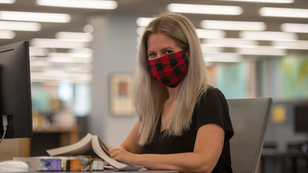 woman wearing mask in library