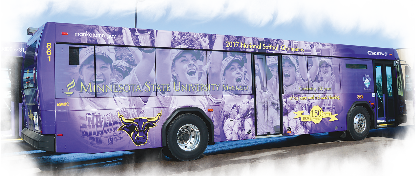 City of Mankato bus with the Minnesota State Mankato logo wrap featuring an image of the 2017 women's softball team national champions