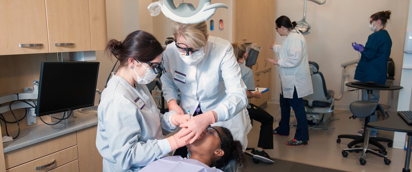 Dental students working on a patient
