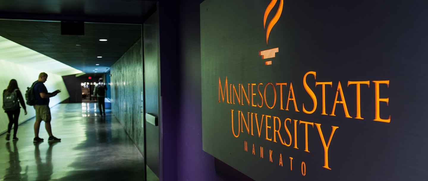 Students walking in the tunnel between the CSU and the library