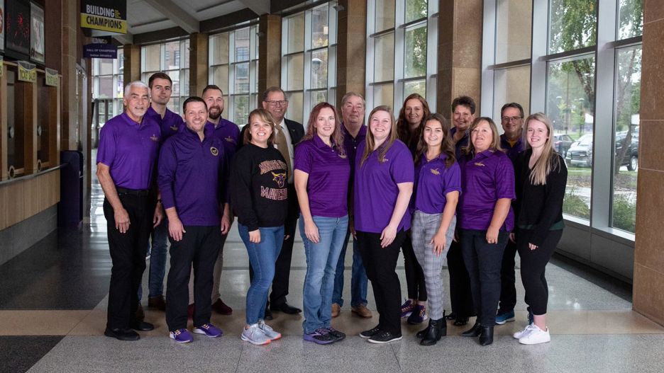 The Alumni Association Board of Directors posing in the Taylor Center hallway