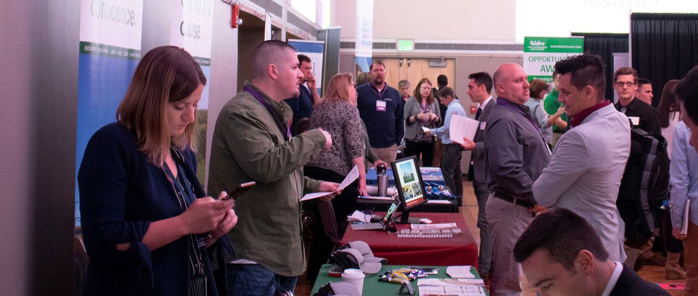 Students interacting with companies at the job fair tables