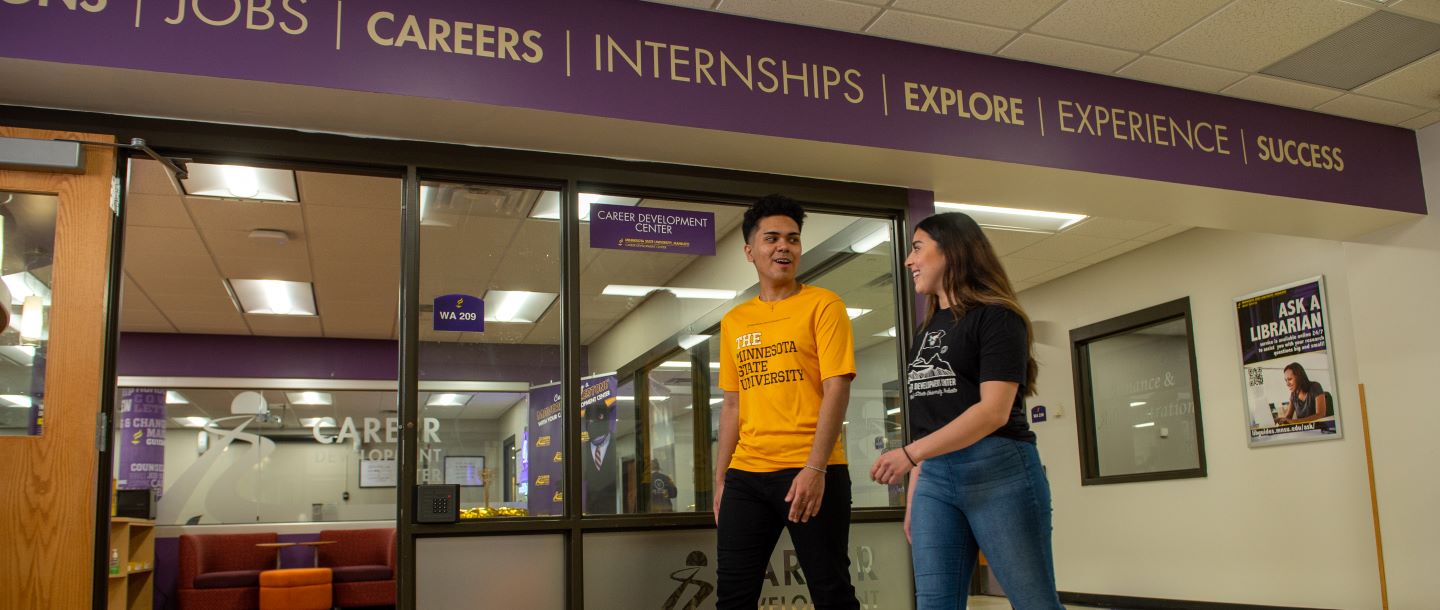 Two students walking by the career development center