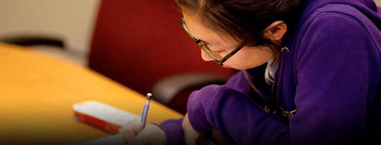 close up of a student, studying in a classroom