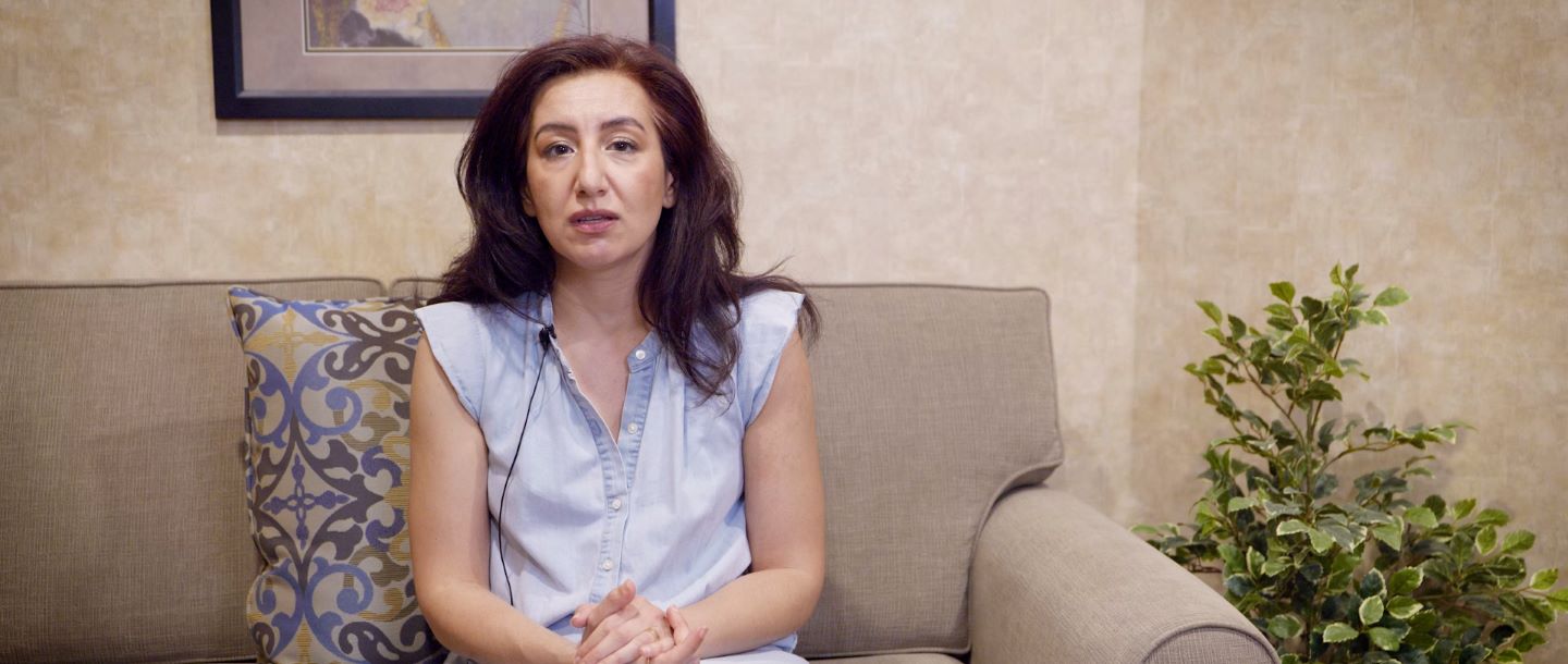 A staff member sitting on a sofa in the lobby