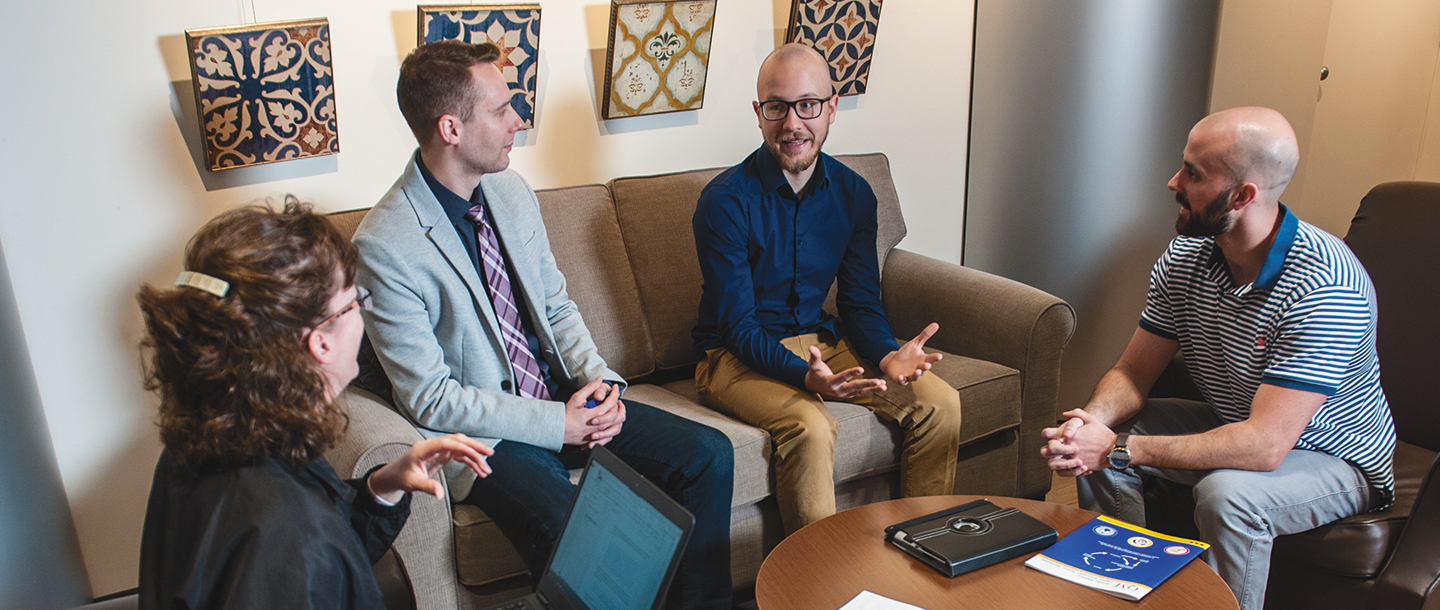 Four faculty members of Minnesota State University brainstorming ideas
