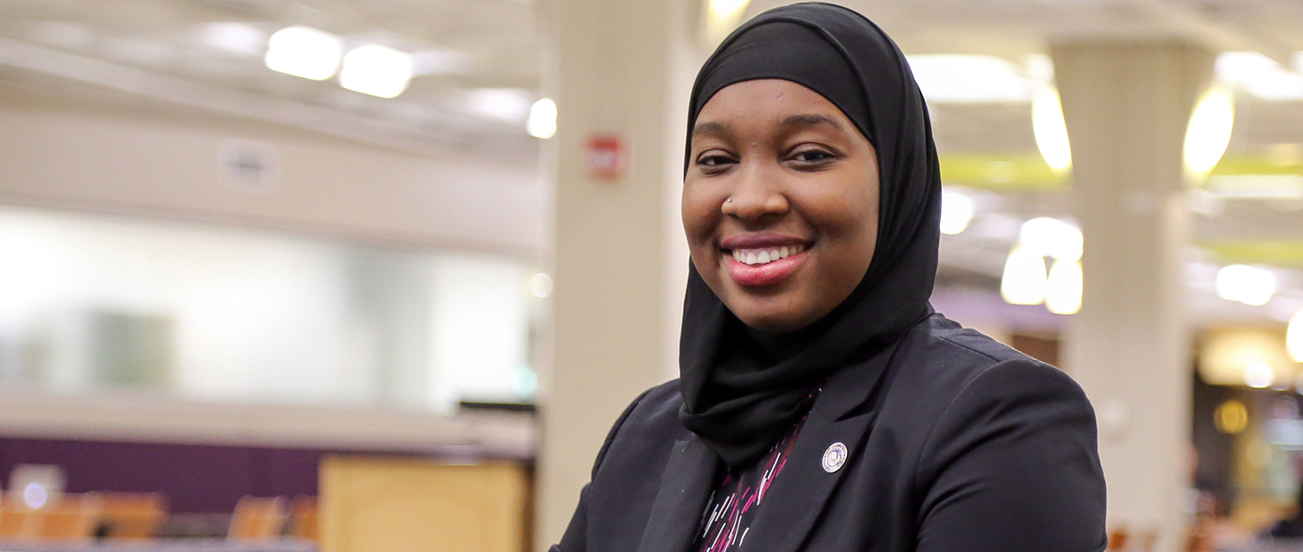a person wearing a black head scarf smiling
