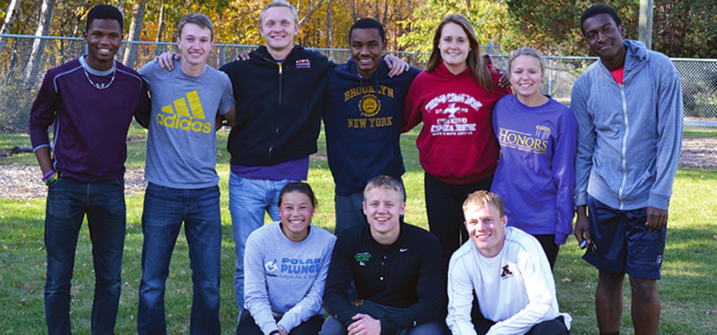 A group of honors students stand in front of the ropes course at Minnesota State University Mankato.