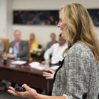 A female leader teaching a certificate program in a classroom setting