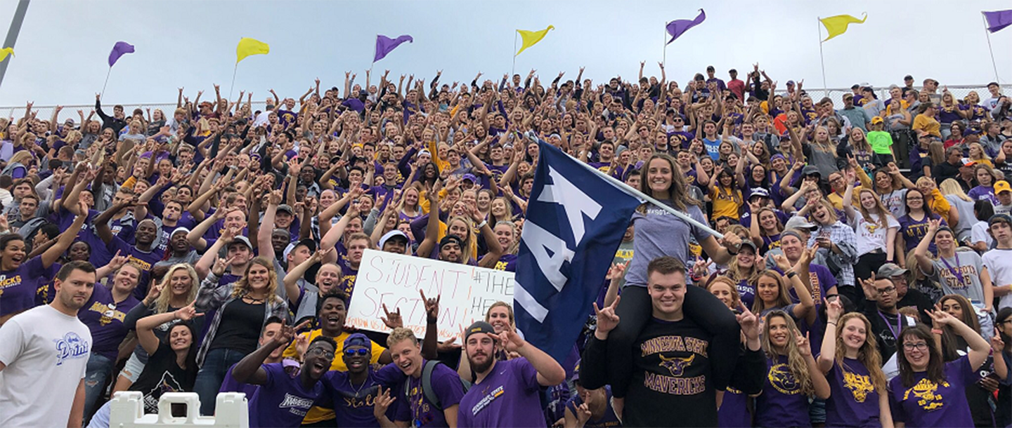 Maverick fans cheering on the bleechers at Blakeslee Stadium during a football game