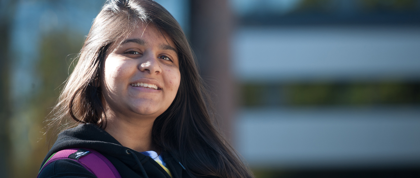 A College girl of color smiling