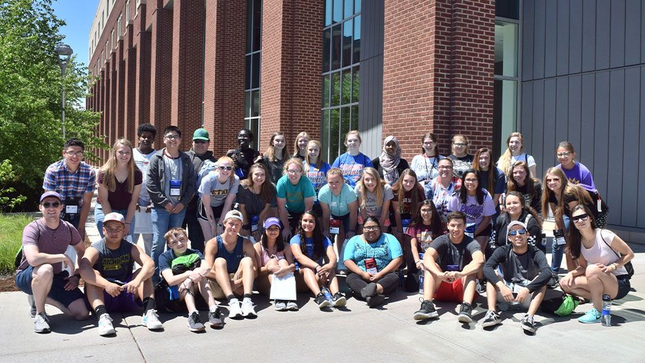ETS high school students posing outside for a group photo during the College Tour Mania