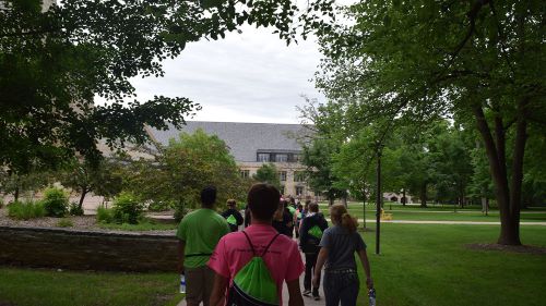 Group of students walking towards the entrance of St. Olaf College
