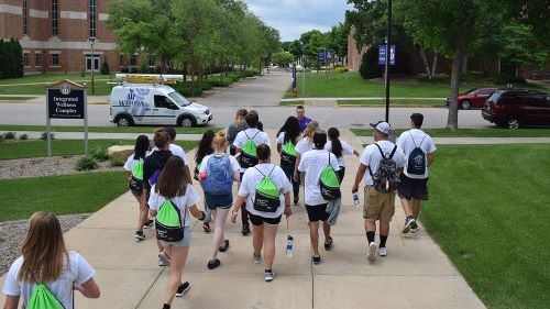 College Tour Mania students walking outside on a tour while visiting Winona State University
