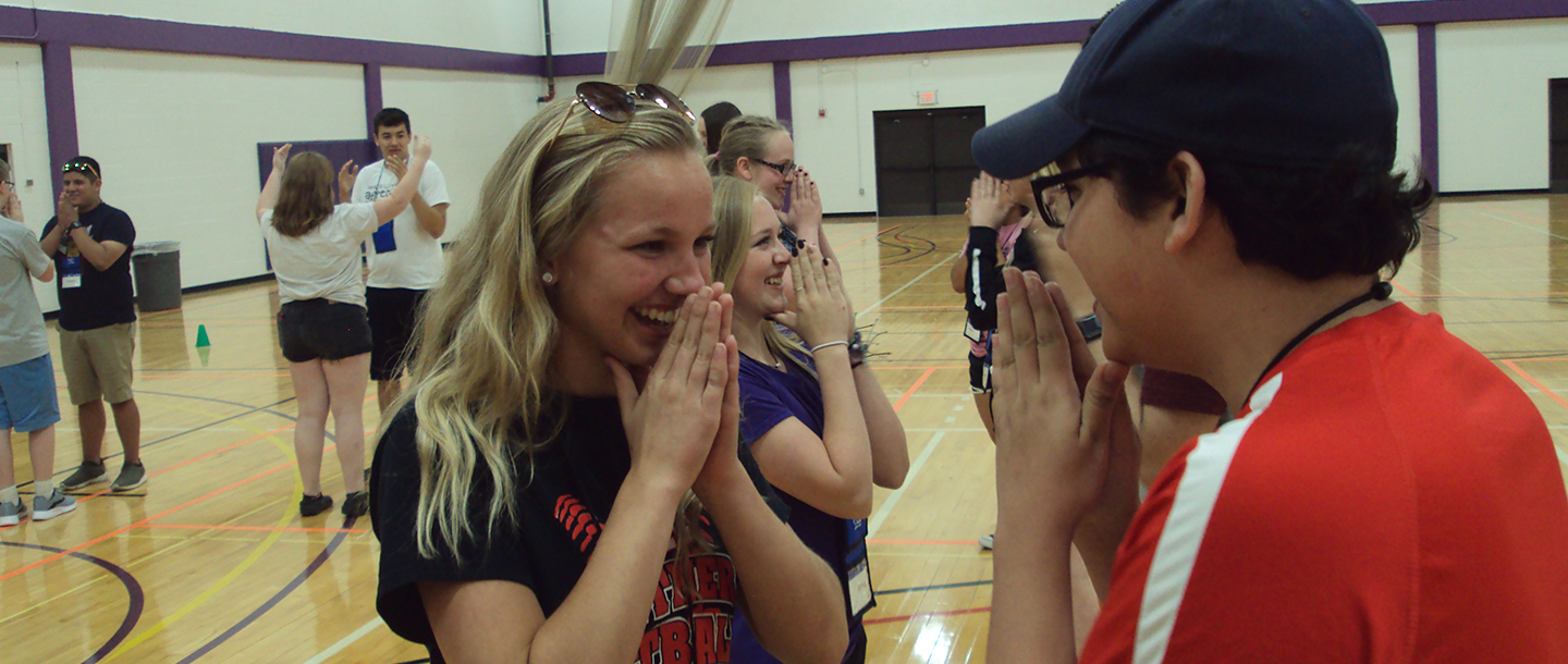 a group of Educational Talent Search students in a gym playing a game