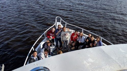 ETS students posing for a picture in a boat on Lake Superior