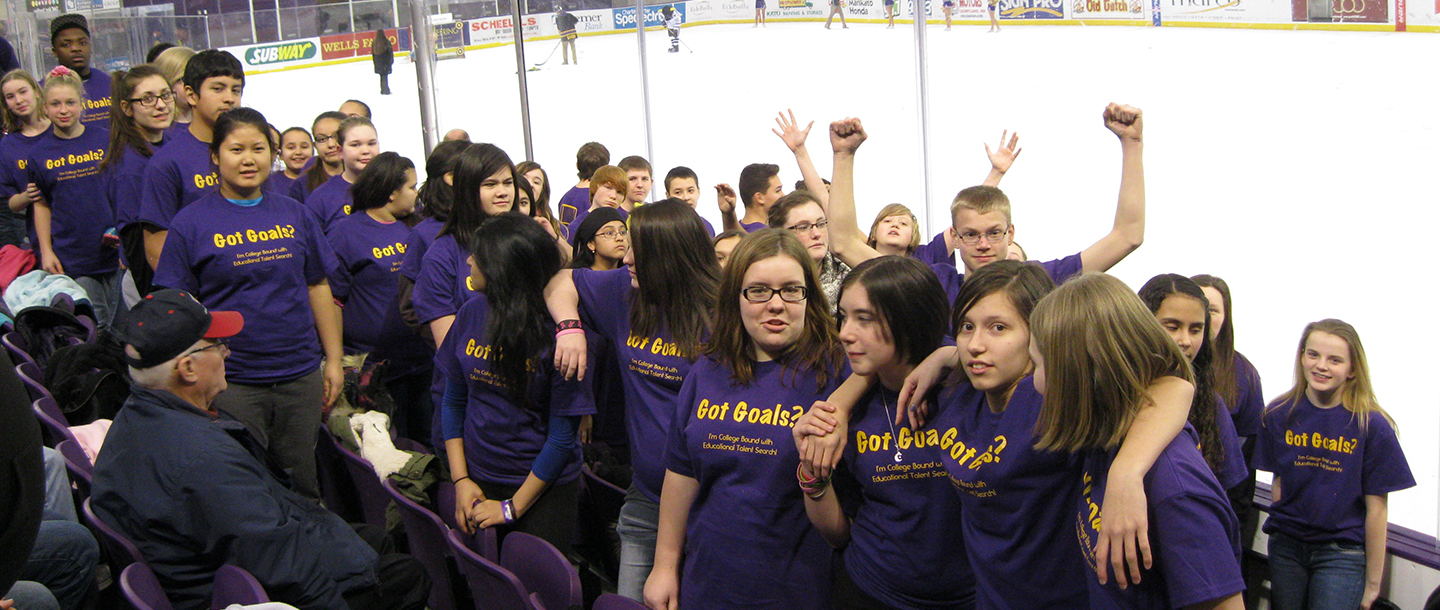 ETS students posing at their seats during a Maverick's hockey game