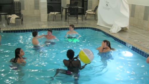 ETS Students playing with a beach ball in a hotel pool during TRIO Day
