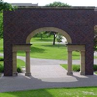 The Alumni Arch and Plaza contain names and sentiments from Minnesota State Mankato alumni and friends represented on the bricks in the plaza located in the arboretum on the east side of campus