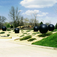 The Spin are black cement cast spheres located at the east entrance of the Trafton Science Center