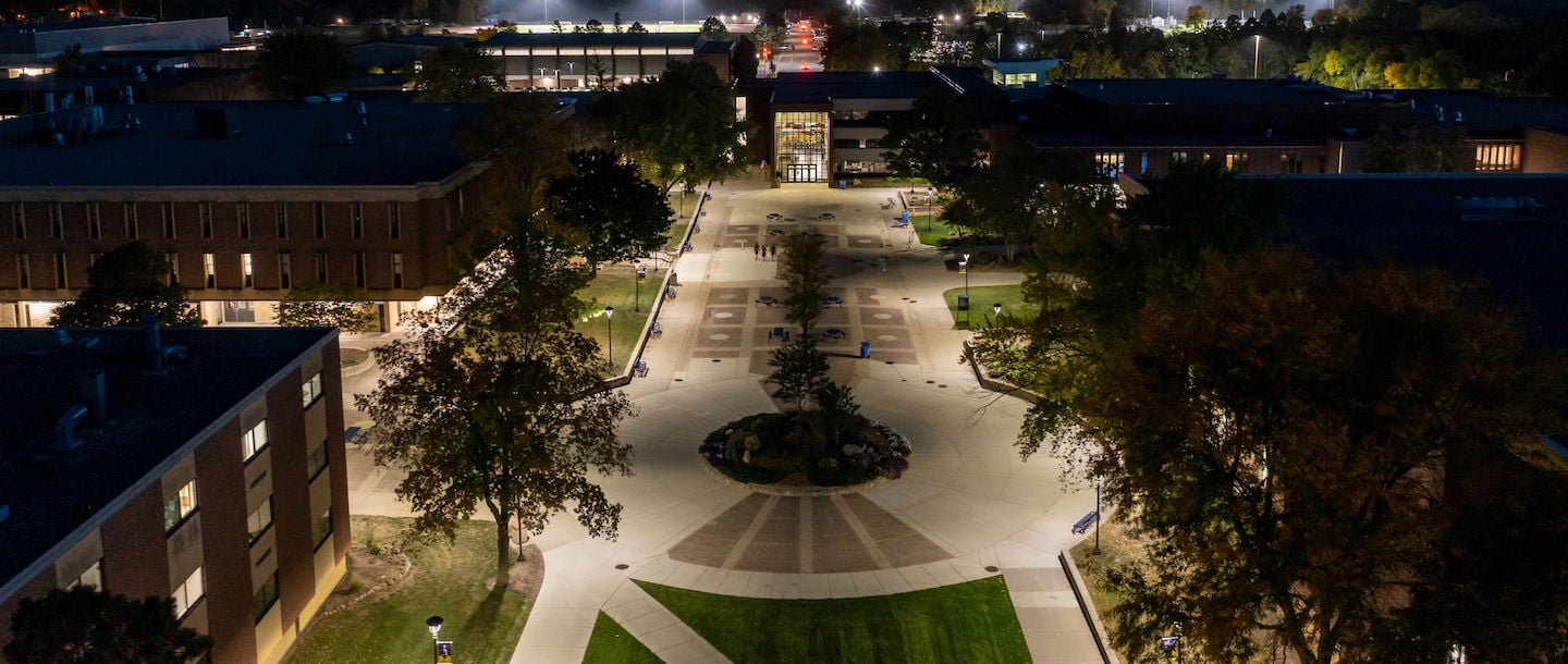 An aerial view of Minnesota State Mankato campus mall after sunset with building and street lights on