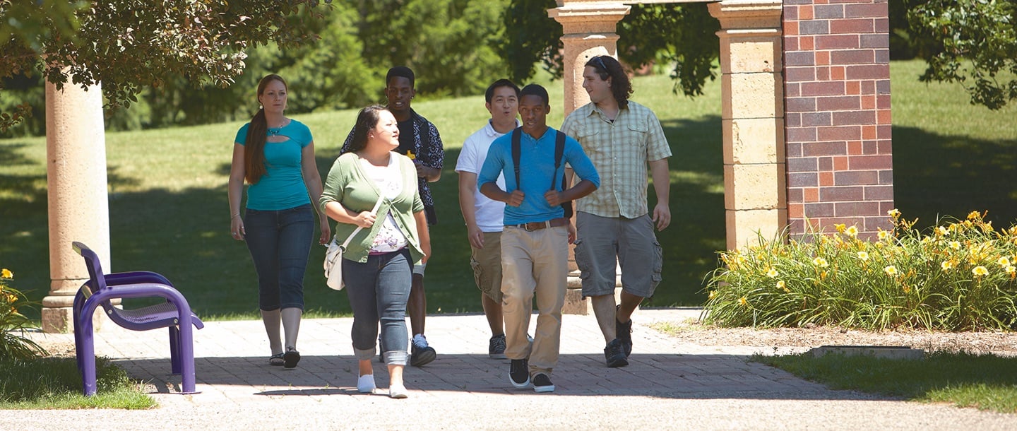 Students walking by Arch