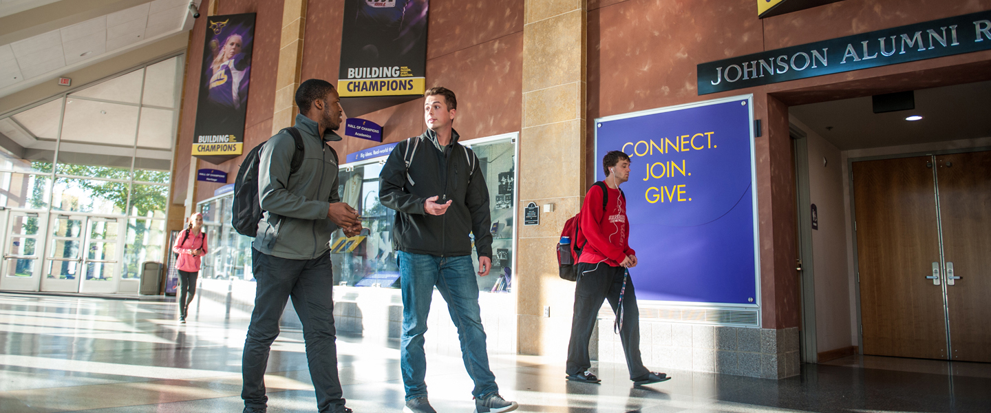 students walking and talking in the hallway of the Taylor Center