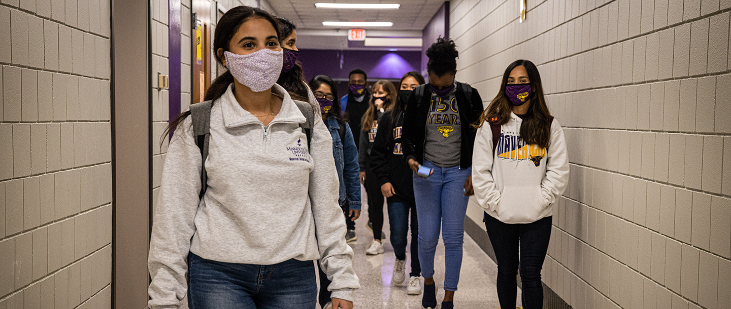 Group of students walking down the hallway
